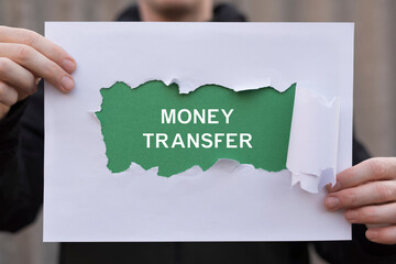 Money Transfer Online Banking Financial Technology Business Concept. Man holding paper sheets banner sees the inscription: MONEY TRANSFER.