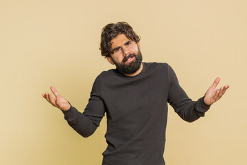 What Why. Sincere irritated Lebanese man raising hands in indignant expression asking reason of...