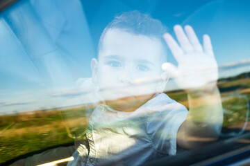 A little boy sits in the car seat.
