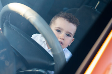 Curious child looking out the car window.