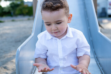 portrait of a little boy on a playground. 
