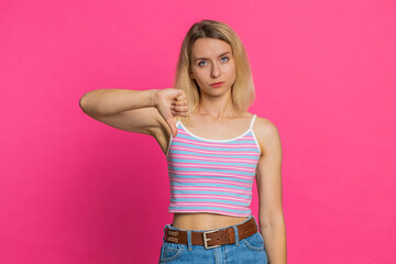Dislike. Upset unhappy Caucasian woman showing thumbs down sign gesture, expressing discontent,...