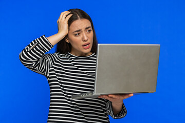 Displeased woman in striped blouse use laptop notebook typing browsing working, loses becoming...