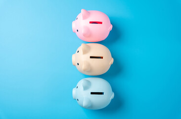 Multicolored piggy banks for savings. Distribution of savings and investments across different economic instruments. Financial diversification. Stocks, bonds, deposits, and pensions.