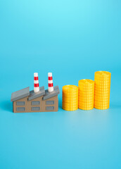 Industrial plant and growing stack of money coins. Increase in income and orders. Increase in wages of workers in factories. Positive impact of government subsidies and contracts.