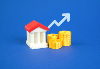Bank building with money and an arrow pointing up. Bank income growth. High liquidity and capitalization. Increased profits, stable liquidity, and strong capital performance. Macroeconomic recovery