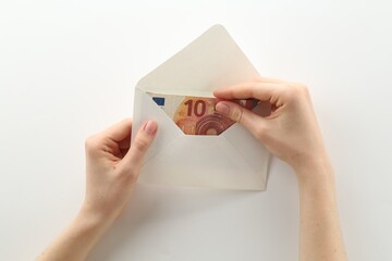Money bonus. Woman holding envelope with euro banknotes on white background, closeup