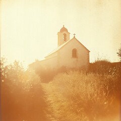 Quaint Church Building with Bell Tower Standing on Hillside Overlooking Path