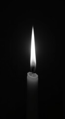 Lit candle that is in the dark