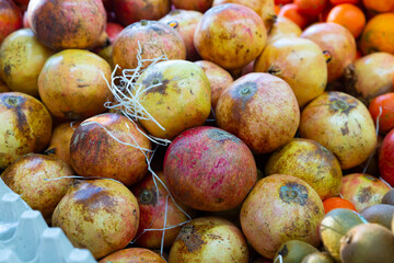 Fresh juicy pomegranate fruit in street farmer's market, healthy food concept
