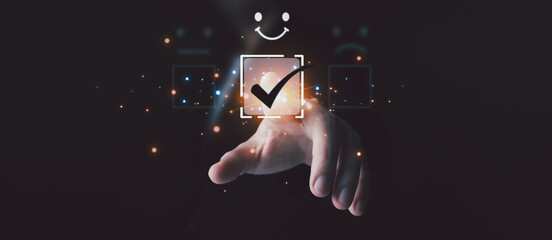 Businessman’s hand selects glowing checkmark on virtual interface, highlighting positive rating and smile icon. Concept of approval, satisfaction, and quality feedback in modern business.