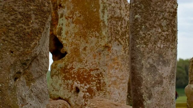 Prehistoric stone pillars and lintels form an iconic monument set on chalky ground at Stonehenge, Salisbury, Wiltshire, England, UK