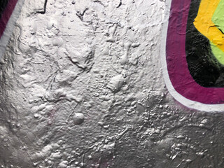 Textured metallic surface with colorful purple graffiti wallpaper background