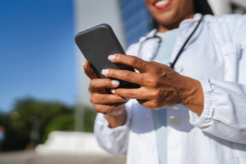 close up on african american female hands use cellphone outdoor