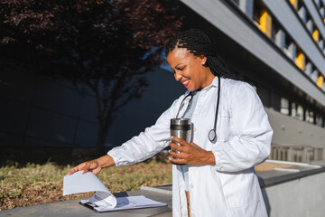 african american woman doctor examining clipboard prepare for patients