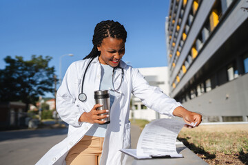 african american woman doctor examining clipboard prepare for patients