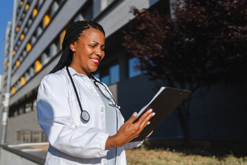 african american woman doctor examining clipboard prepare for patients