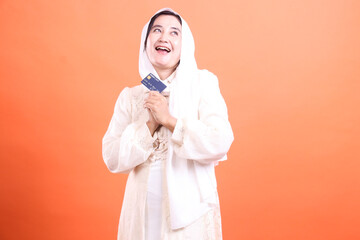 Delighted Muslim Woman with Credit Card: Optimistic financial future with secure digital transactions and convenient online shopping options.