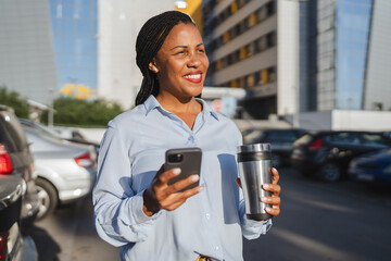 african american woman enjoy on coffee break while use mobile phone