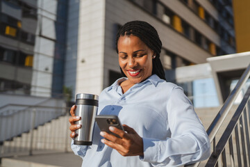 african american woman enjoy on coffee break while use mobile phone