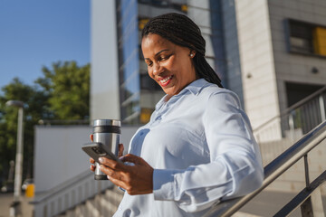 african american woman enjoy on coffee break while use mobile phone
