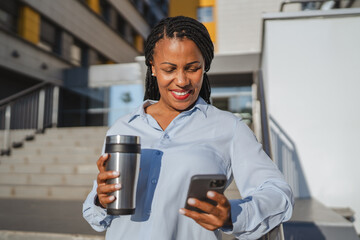 african american woman enjoy on coffee break while use mobile phone