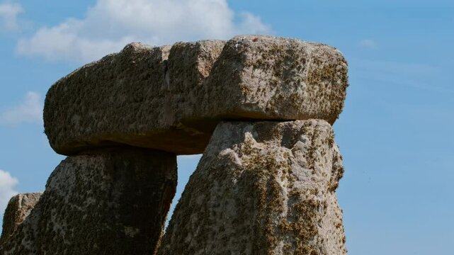 Prehistoric stone pillars and lintels form an iconic monument set on chalky ground at Stonehenge, Salisbury, Wiltshire, England, UK