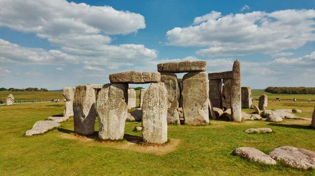 Prehistoric stone pillars and lintels form an iconic monument set on chalky ground at Stonehenge, Salisbury, Wiltshire, England, UK