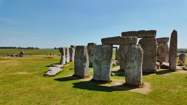 Prehistoric stone pillars and lintels form an iconic monument set on chalky ground at Stonehenge, Salisbury, Wiltshire, England, UK