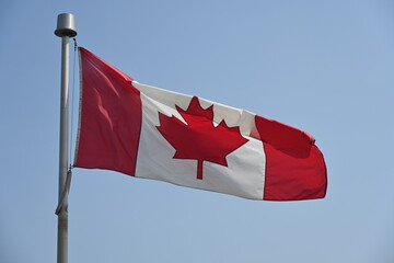 canadian flag against blue sky