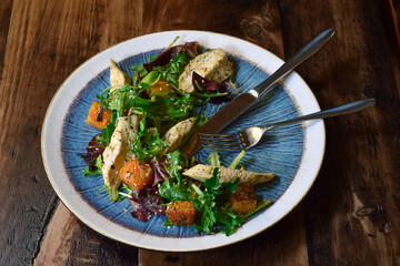 Salad with grilled chicken, fresh salad greens and roasted squash