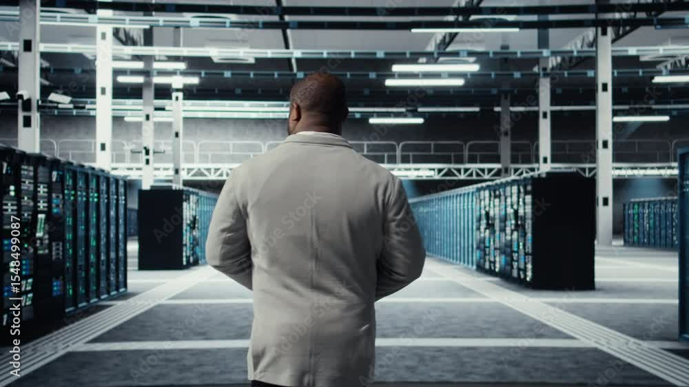 Poster system administrator walking in data center with rows of fully operational rackmounts. it expert ove