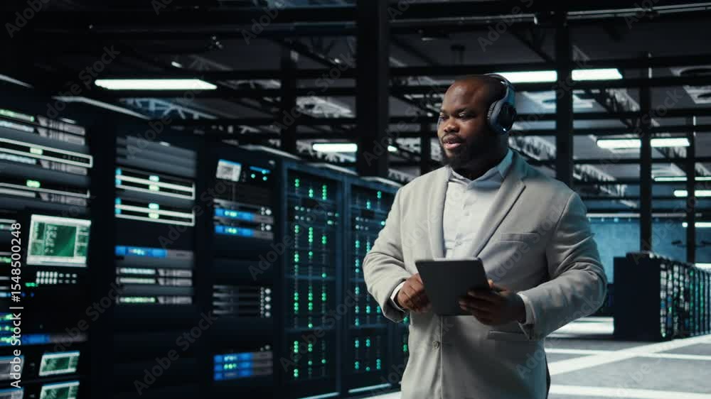 Poster data center admin wearing headphones using tablet to identify bottlenecks. server farm it expert lis