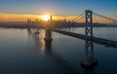 San Francisco-Oakland Bay Bridge, USA, at sunset. Cars travel across the bridge, connecting San...