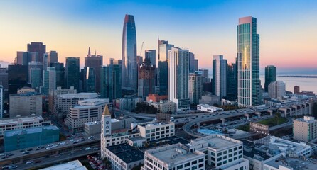 Aerial view of San Francisco, California, USA, at sunrise. Cars travel on the highway through the...