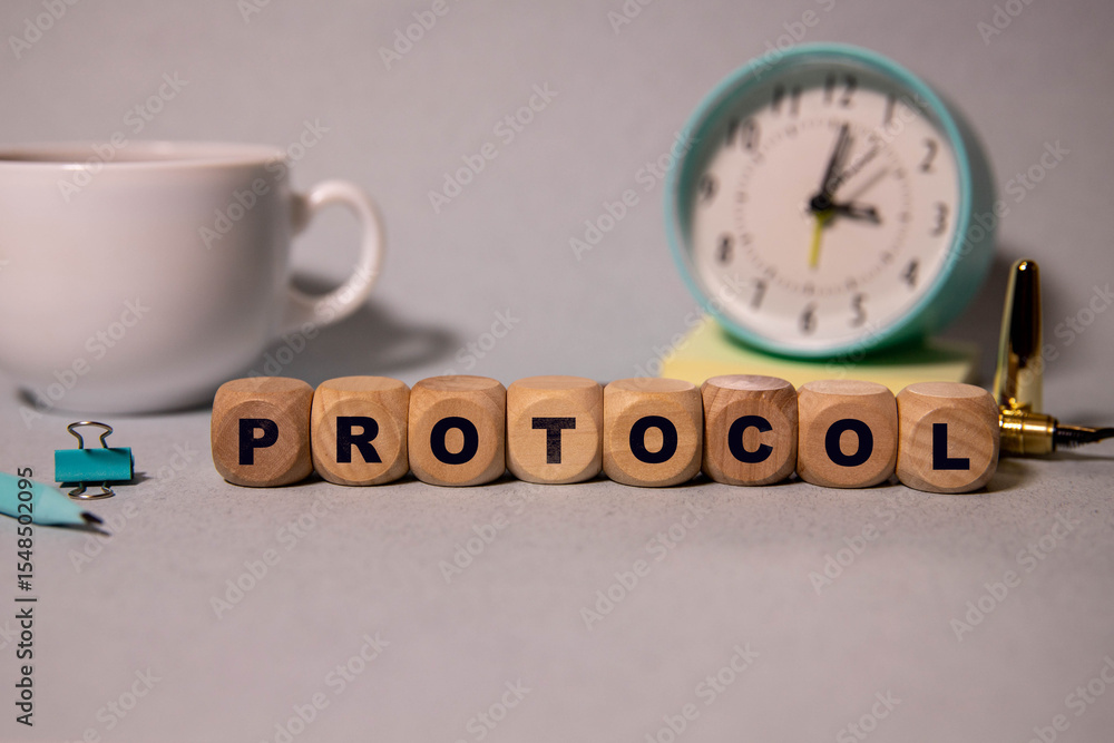 Poster text protocol is written on a folder lying on a stack of papers with a pen on the table.