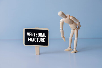 Doctor's hands glue a medical plaster on the mockup of the intervertebral disc, blue background.