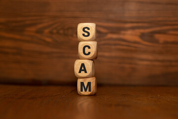 SCAM symbol. Copy space. Concept word SCAM on wooden blocks