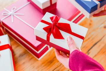  Gifts set with Ribbons.Hand Holding Blue Gift Box with Ribbon.Mothers Day, Birthday, Christmas...