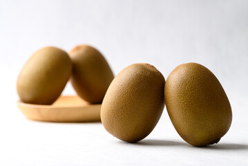 Fresh kiwi fruit with wooden plate on white background, Healthy fruit