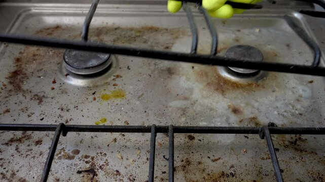Close up of very dirty greasy surface of gas stove. House cleaning service