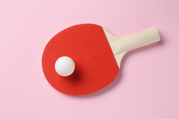 Ping pong racket and ball on pink background, top view
