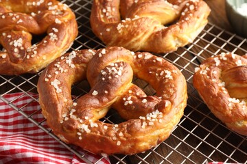 Tasty pretzels with salt on table, closeup