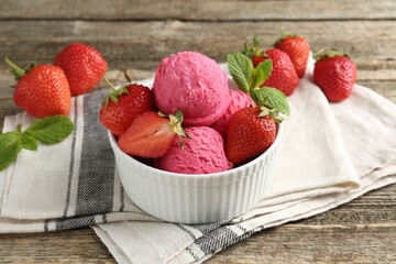 Tasty sorbet with strawberries and mint served on wooden table, closeup