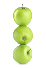 Green apples stacked on top of each other against white background. Balance