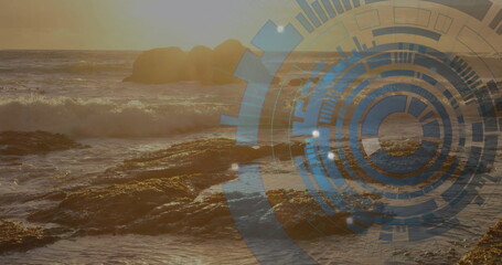 Crashing sunlit ocean waves hitting jagged rocky shoreline at sunset, with digital HUD graphic