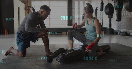 Training duo wearing athletic wear demonstrating grappling hold on mat at gym with grappling dummy