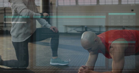 Kneeling trainer coaching man holding forearm plank at gym, blue exercise mat, copy space