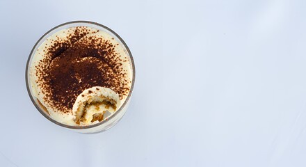 Indulge in the Decadent Delight of a Creamy, Coffee-Infused Tiramisu, Partially Eaten, Showcasing its Exquisite Layers and Rich Cocoa Dusting.