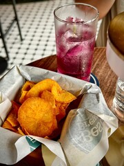 Drinks and potato chips at a fancy bar